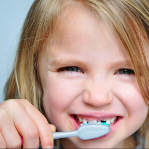 kid brushing her teeth